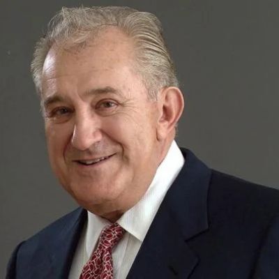 He is wearing suit with a white shirt and a tie.